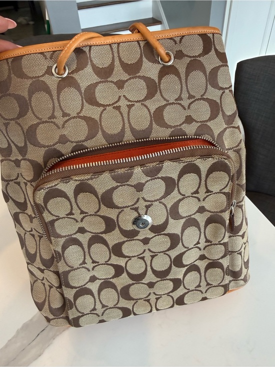 coach backpack purse brown West Pack Sling Bag 2540 Pebble Leather Crossbody Signature coated canvas Inside zip cell phone and multifunction pockets Laptop compartment with zip closure Zip closure recycled polyester lining Top handle with 2 drop Outside zip pockets Adjustable shoulder straps Fits a 12 (zip compartment) or 13 (main compartment) laptop 10 3/4 (L) x 14 (H) x 5 1/4 (W) Style No. Coach Backpack Purses - DA'
